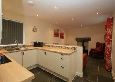 Kitchen area with living room area in the background
