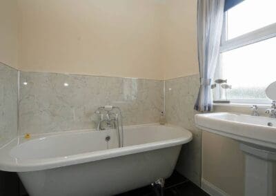Main bathroom with bath and sink